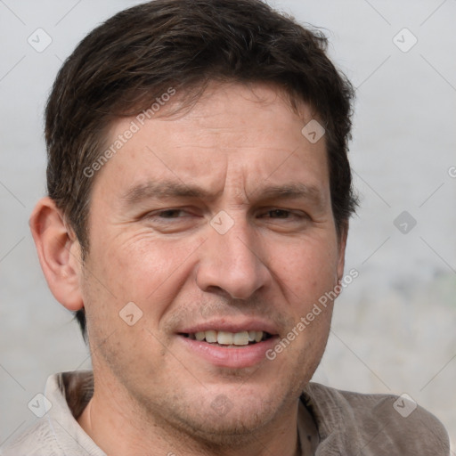 Joyful white adult male with short  brown hair and grey eyes