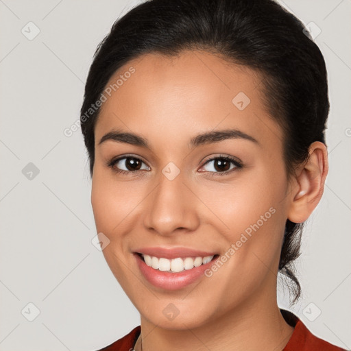 Joyful latino young-adult female with medium  brown hair and brown eyes