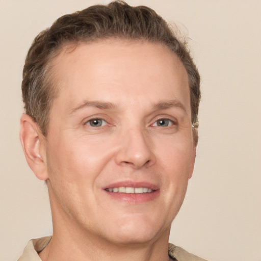 Joyful white adult male with short  brown hair and grey eyes