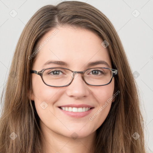 Joyful white young-adult female with long  brown hair and green eyes