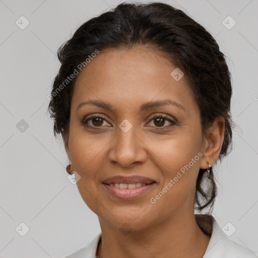 Joyful latino adult female with medium  brown hair and brown eyes