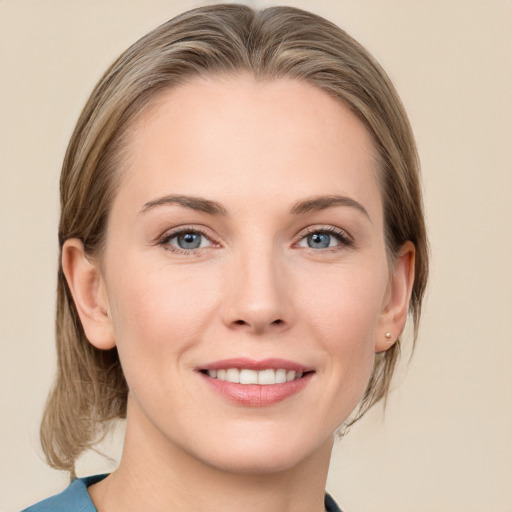 Joyful white young-adult female with medium  brown hair and blue eyes