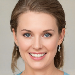 Joyful white young-adult female with medium  brown hair and blue eyes