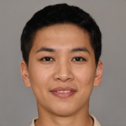 Joyful latino young-adult male with short  brown hair and brown eyes