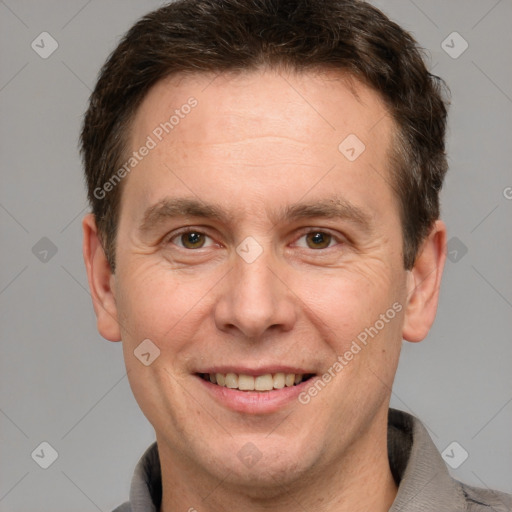 Joyful white adult male with short  brown hair and grey eyes