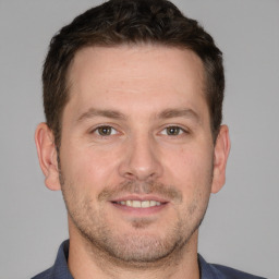 Joyful white adult male with short  brown hair and brown eyes