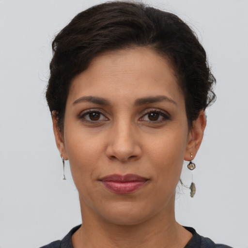 Joyful latino young-adult female with short  brown hair and brown eyes