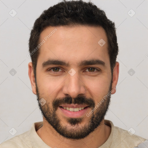 Joyful white young-adult male with short  black hair and brown eyes