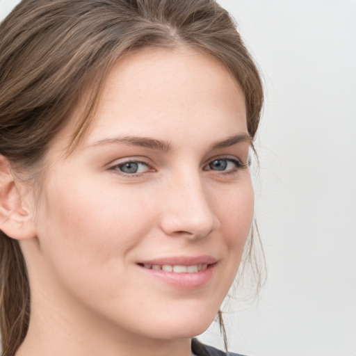 Joyful white young-adult female with long  brown hair and blue eyes