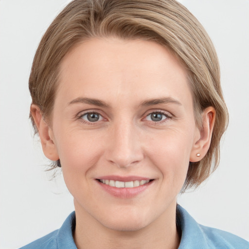 Joyful white young-adult female with medium  brown hair and grey eyes