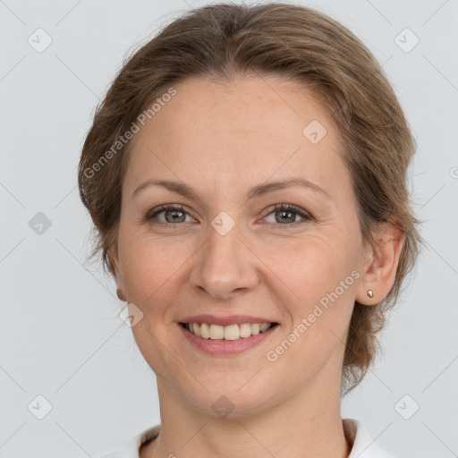 Joyful white adult female with medium  brown hair and grey eyes