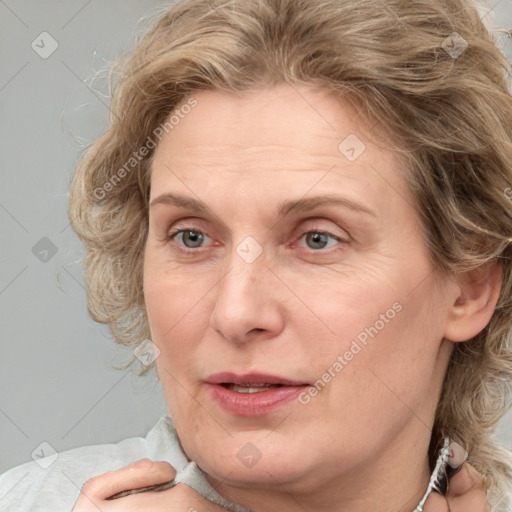 Joyful white adult female with medium  brown hair and blue eyes