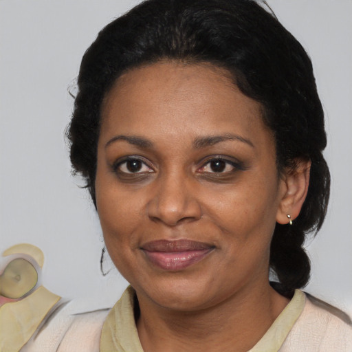 Joyful black adult female with medium  black hair and brown eyes