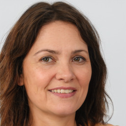 Joyful white adult female with long  brown hair and brown eyes