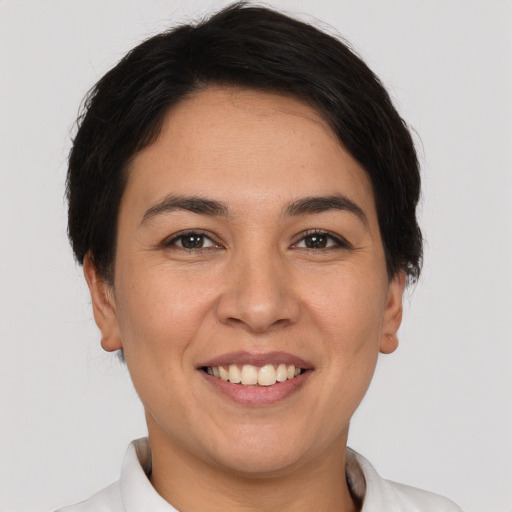 Joyful white young-adult female with short  black hair and brown eyes