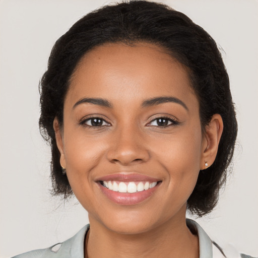 Joyful latino young-adult female with long  brown hair and brown eyes