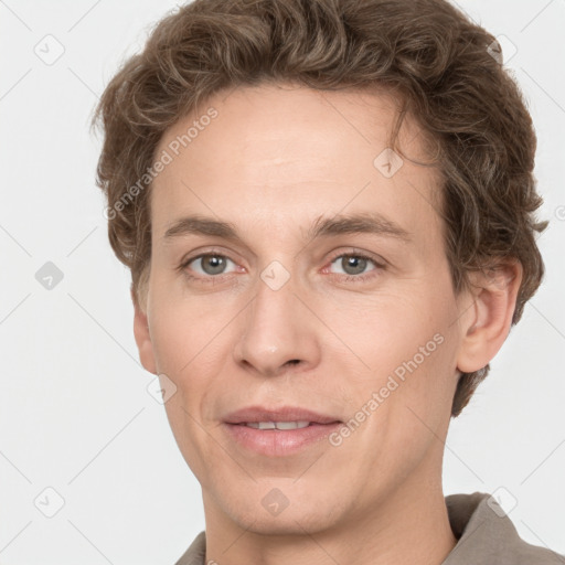 Joyful white adult male with short  brown hair and grey eyes