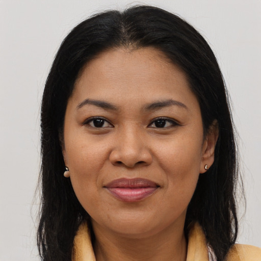 Joyful asian adult female with long  brown hair and brown eyes