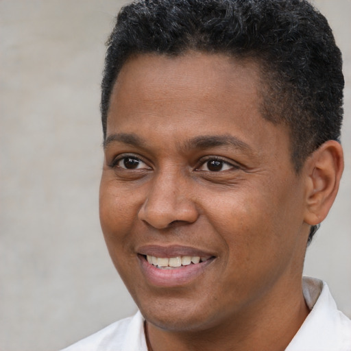 Joyful latino young-adult male with short  brown hair and brown eyes