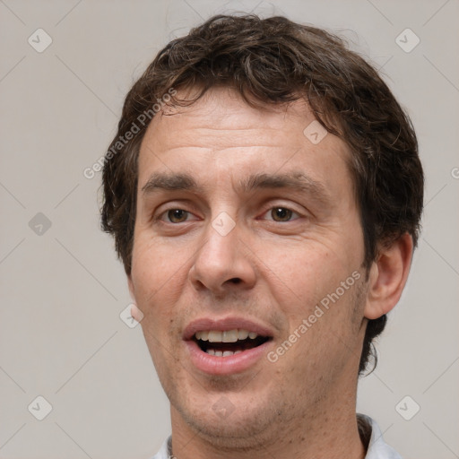 Joyful white adult male with short  brown hair and brown eyes