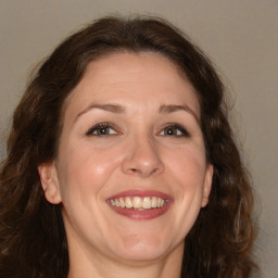 Joyful white adult female with medium  brown hair and brown eyes