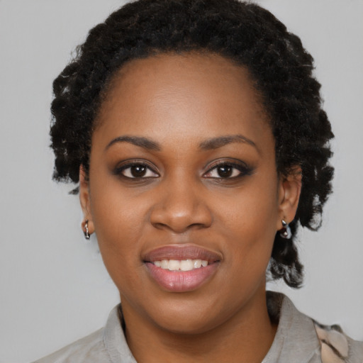 Joyful black young-adult female with medium  black hair and brown eyes