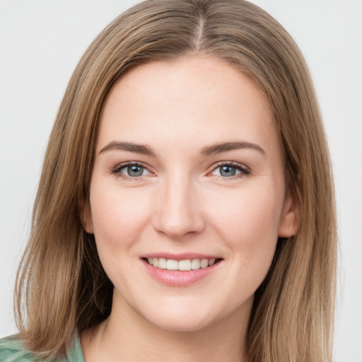 Joyful white young-adult female with medium  brown hair and green eyes