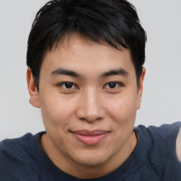 Joyful asian young-adult male with short  brown hair and brown eyes