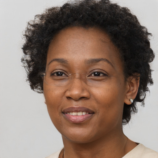 Joyful black adult female with short  brown hair and brown eyes