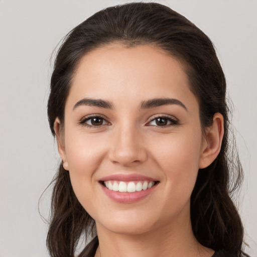 Joyful white young-adult female with medium  brown hair and brown eyes