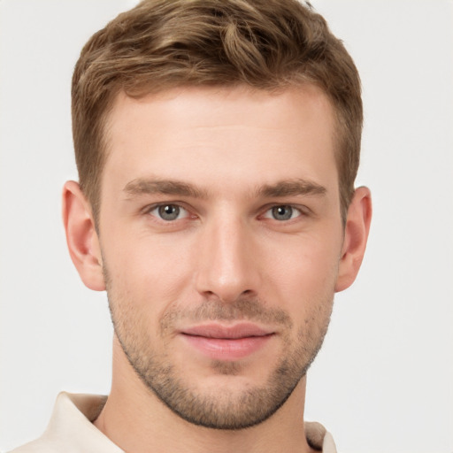 Joyful white young-adult male with short  brown hair and grey eyes