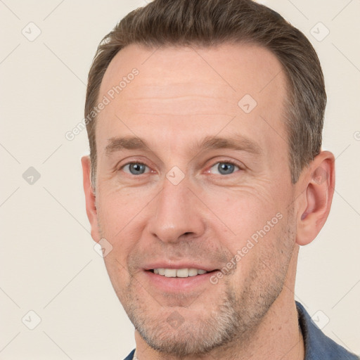 Joyful white adult male with short  brown hair and grey eyes