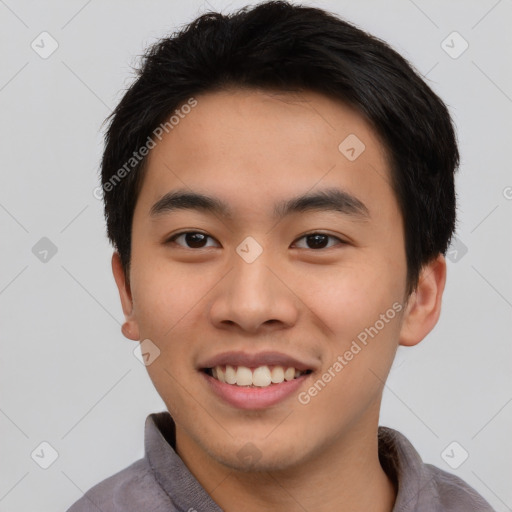 Joyful asian young-adult male with short  black hair and brown eyes