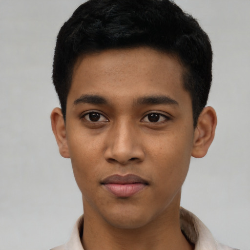 Joyful latino young-adult male with short  black hair and brown eyes
