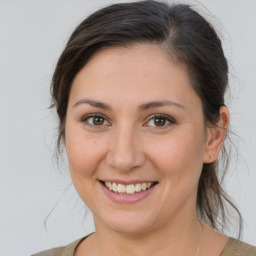 Joyful white young-adult female with medium  brown hair and brown eyes