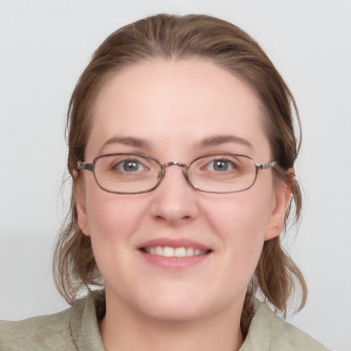 Joyful white young-adult female with medium  brown hair and blue eyes