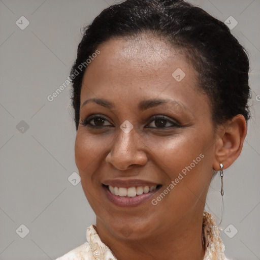 Joyful black young-adult female with short  brown hair and brown eyes