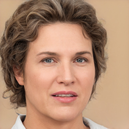 Joyful white young-adult female with medium  brown hair and green eyes