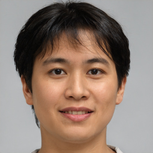 Joyful asian young-adult male with short  brown hair and brown eyes