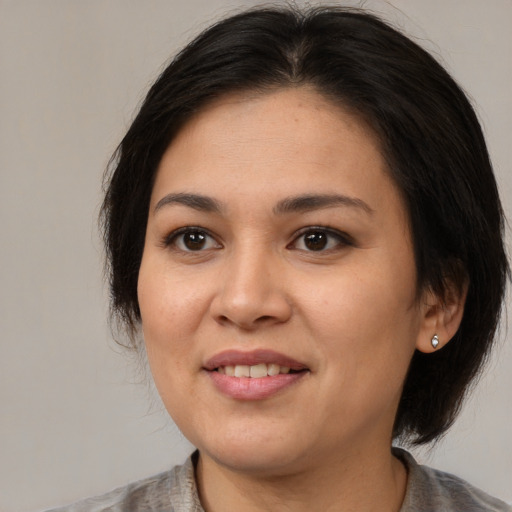 Joyful asian young-adult female with medium  brown hair and brown eyes