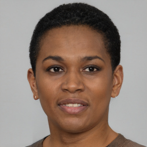 Joyful black young-adult female with short  black hair and brown eyes