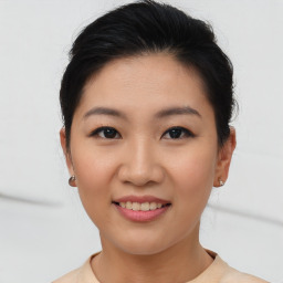 Joyful asian young-adult female with short  brown hair and brown eyes