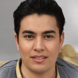 Joyful latino young-adult male with short  brown hair and brown eyes