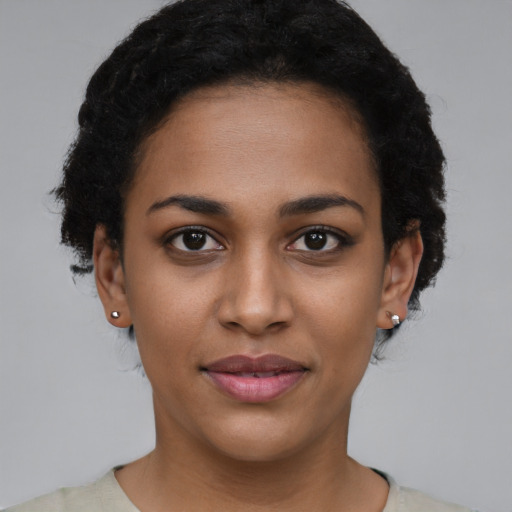 Joyful latino young-adult female with short  brown hair and brown eyes