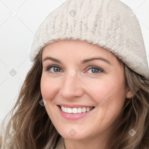 Joyful white young-adult female with long  brown hair and blue eyes