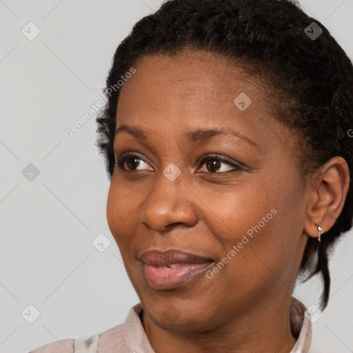 Joyful black adult female with short  brown hair and brown eyes