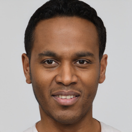 Joyful black young-adult male with short  black hair and brown eyes