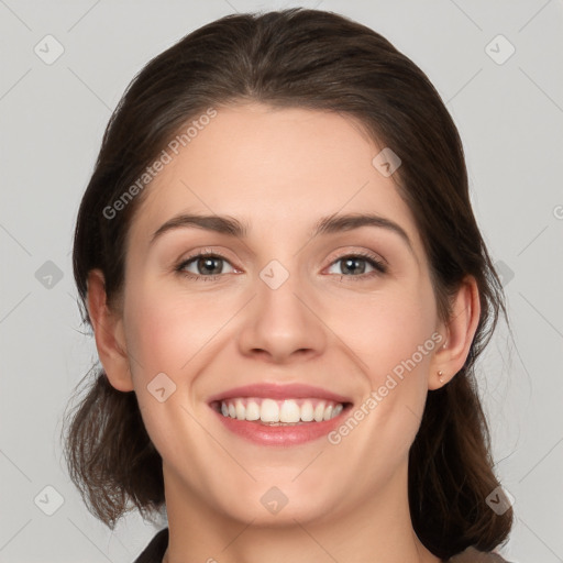 Joyful white young-adult female with medium  brown hair and grey eyes