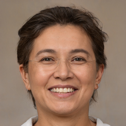 Joyful white adult female with medium  brown hair and brown eyes