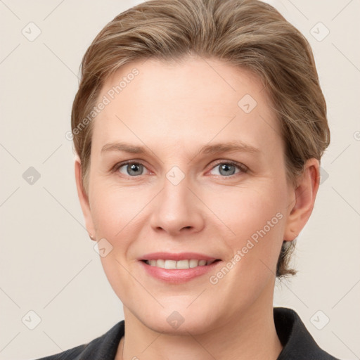 Joyful white young-adult female with short  brown hair and grey eyes